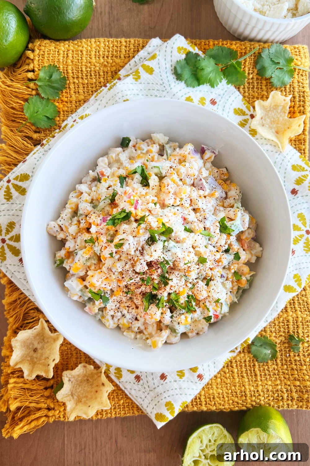 Vibrant Mexican street corn salad in a serving bowl, generously topped with crumbled Cotija cheese and fresh green cilantro, ready to be enjoyed.