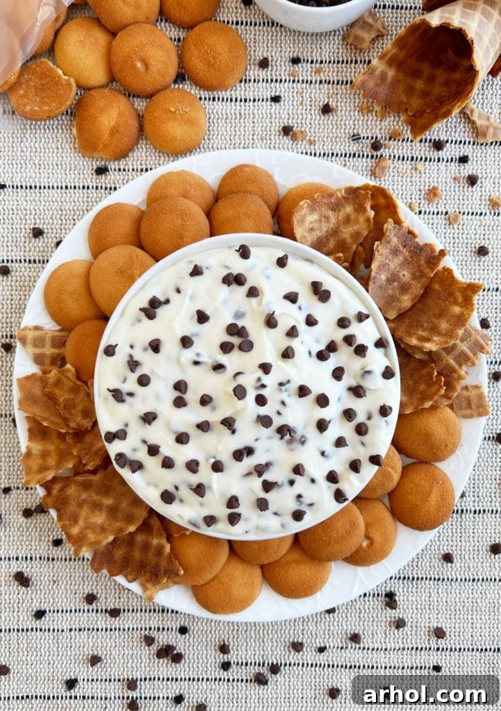 bowl of cannoli dip with mini  chips on platter with dippers