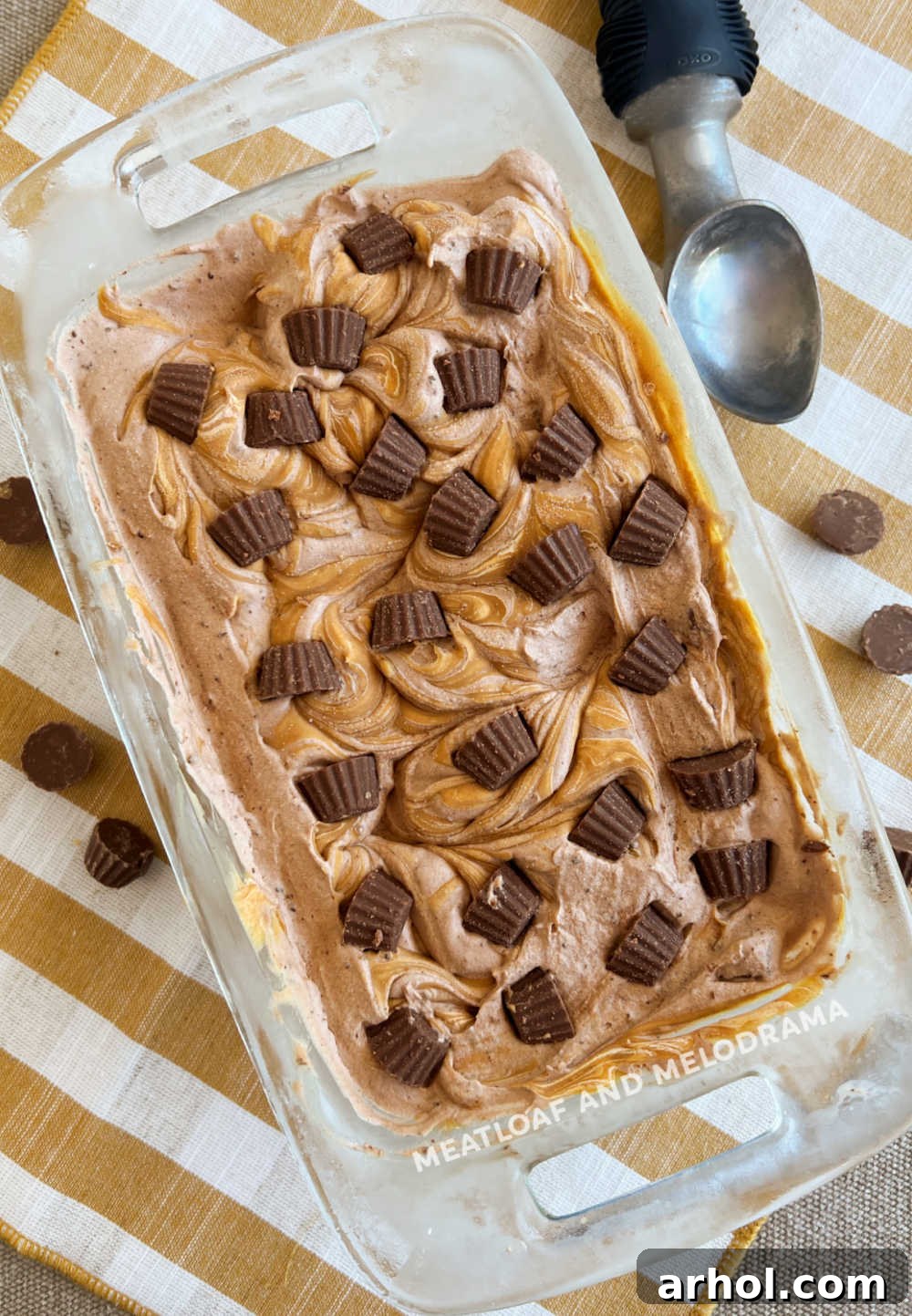 No-Churn Chocolate Peanut Butter Bliss 8 A loaf pan filled with homemade chocolate peanut butter ice cream, topped with mini Reese's cups, perfectly frozen and ready to scoop.