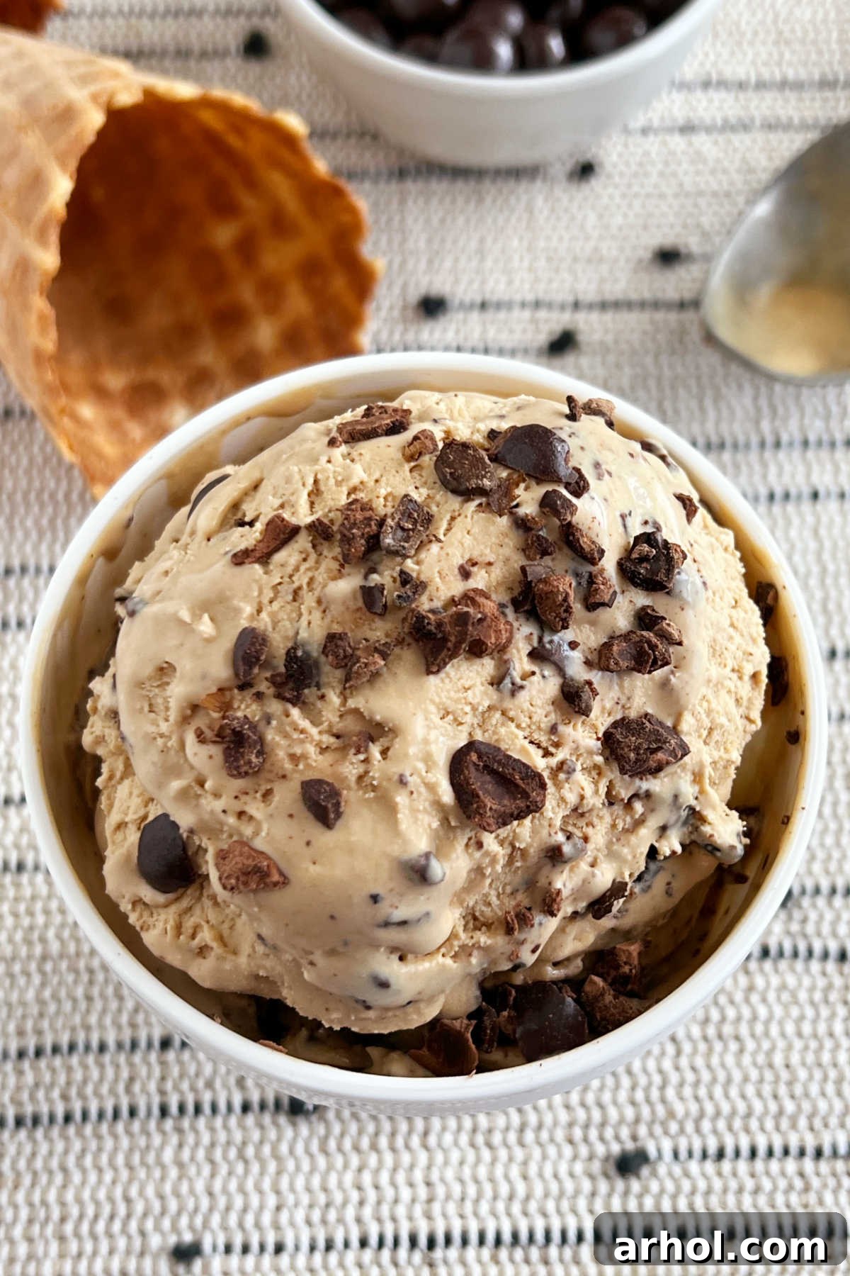 Bowl of no-churn coffee ice cream topped with chocolate covered espresso beans.