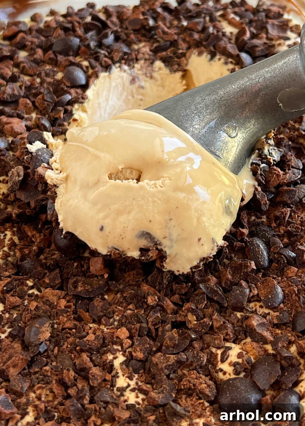 Scooping homemade coffee ice cream with an ice cream scoop.