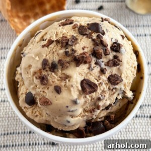 Bowl of no-churn coffee ice cream with chocolate covered espresso beans on top.