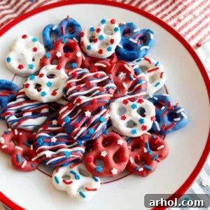 Red, White, and Blue pretzels with patriotic sprinkles on a red and white plate, showcasing a festive arrangement.