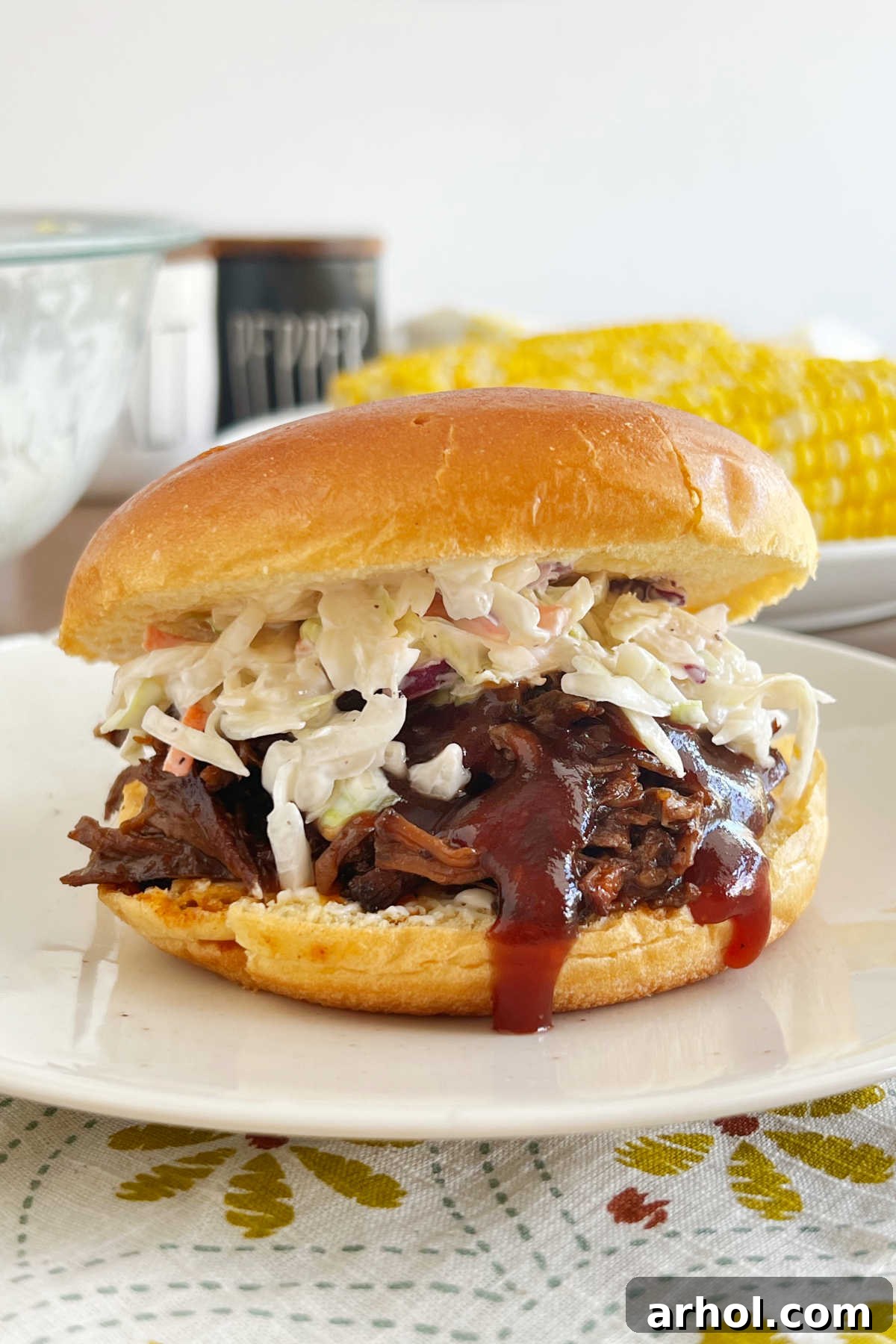 crock pot bbq beef sandwiches on bun with coleslaw.