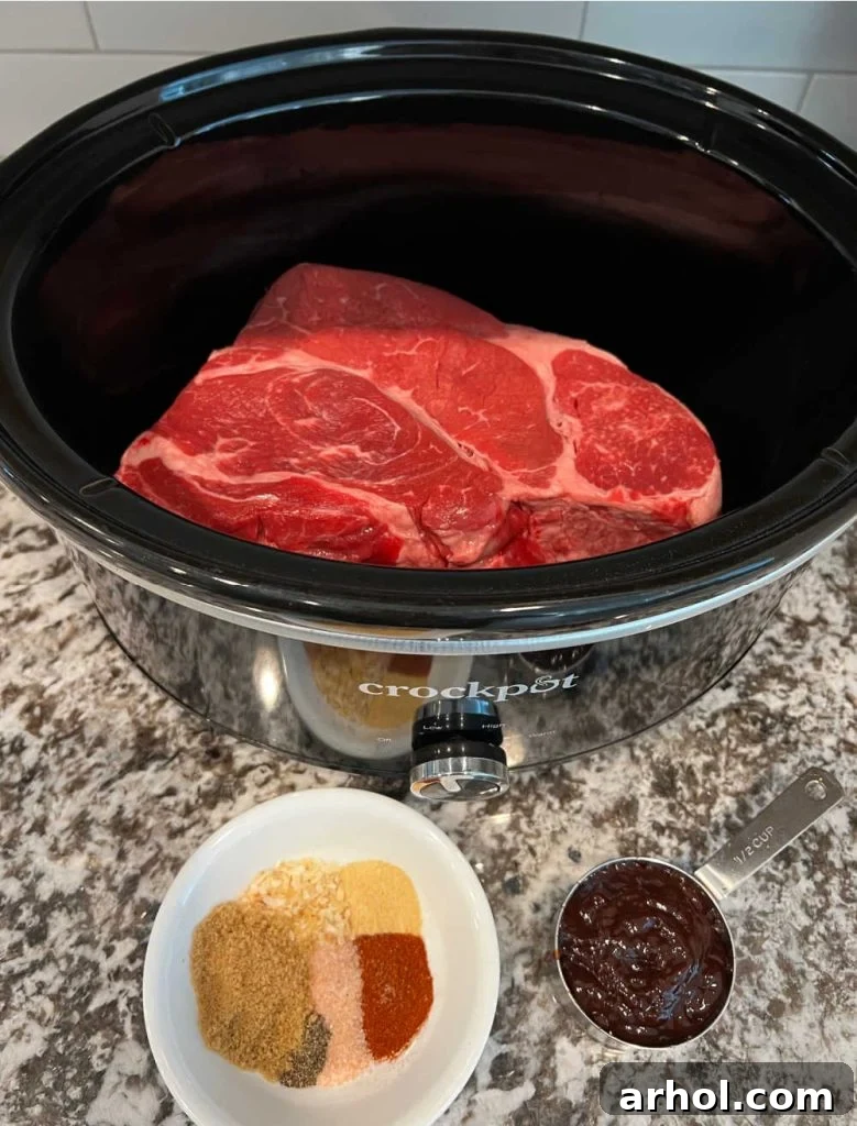 boneless chuck roast in slow cooker, bbq sauce and spices.