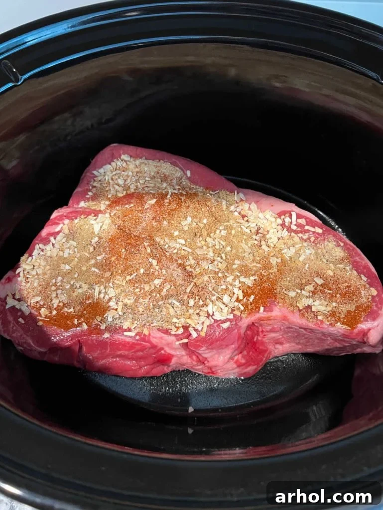chuck roast in slow cooker with spice rub.