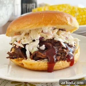 crock pot bbq beef sandwich with coleslaw on a bun.