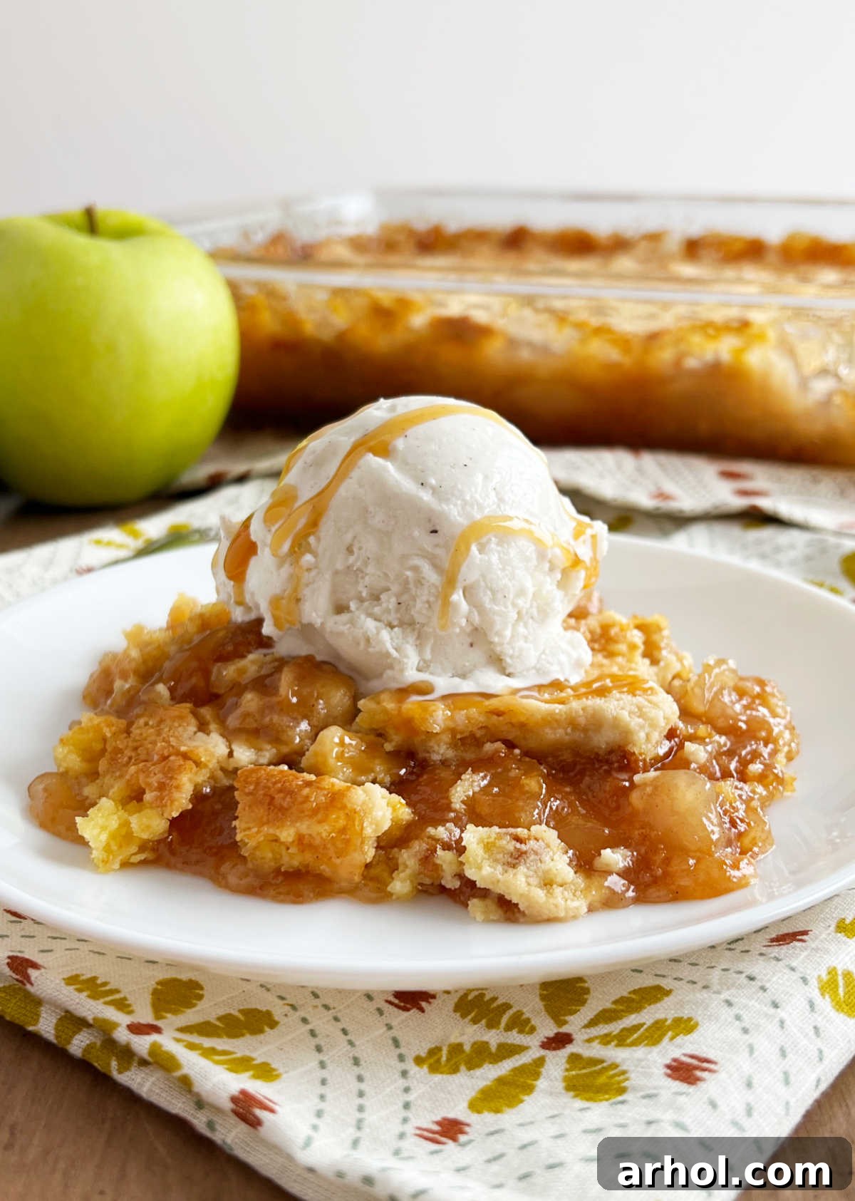 Effortless Caramel Apple Dump Cake 2 Delicious slice of warm Caramel Apple Dump Cake topped with melting vanilla ice cream and a luscious caramel drizzle, perfect for fall.