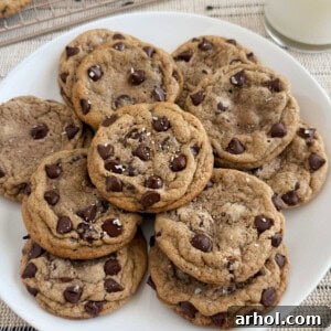 plate of chewy chocolate chip cookies with flaky salt on top.