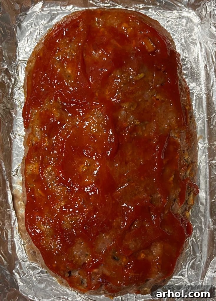 meatloaf with ketchup in baking dish.