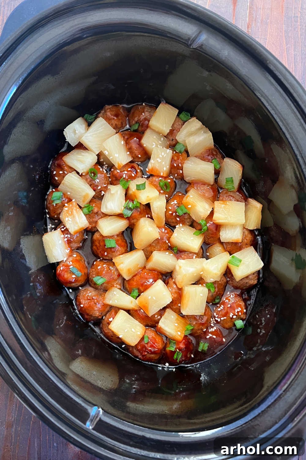 Delicious teriyaki meatballs with pineapple, cooked in a slow cooker, served as a main dish.