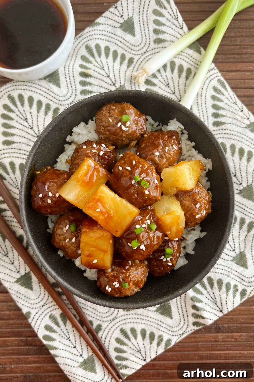 A bowl of slow cooker teriyaki pineapple meatballs on a table, ready to be served.