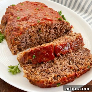 Quaker oats meatloaf with ketchup glaze sliced on a platter.