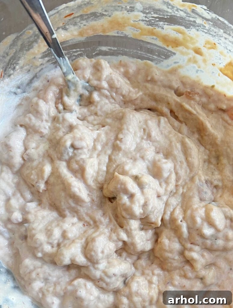 Mixing cream of chicken soup, salsa, sour cream, and taco seasoning in a bowl.