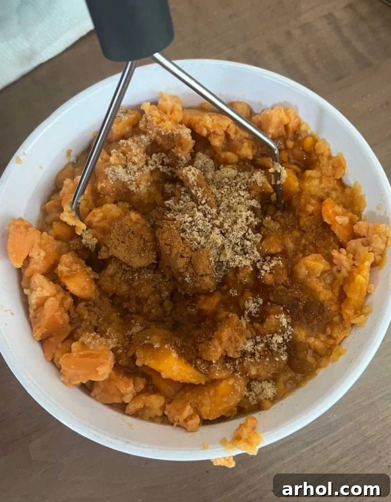 mash casserole ingredients with potato masher.