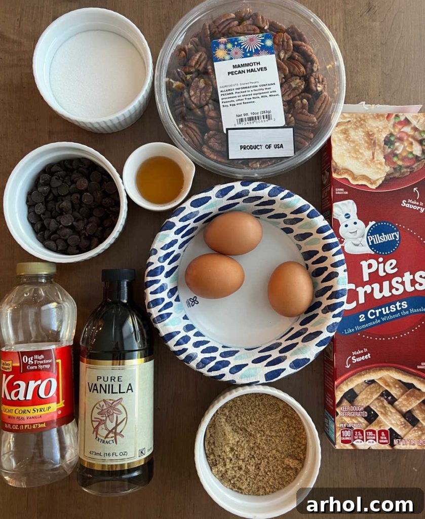A beautifully arranged flat lay of all necessary ingredients for baking a delicious bourbon chocolate pecan pie: whole pecan halves, an unbaked pie crust, fresh eggs, light corn syrup, pure vanilla extract, brown sugar, granulated white sugar, melted butter, a bottle of bourbon, and semi-sweet chocolate chips.