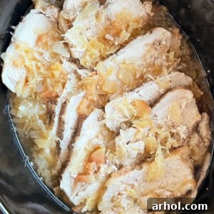Pork roast and sauerkraut cooked in a crock pot.