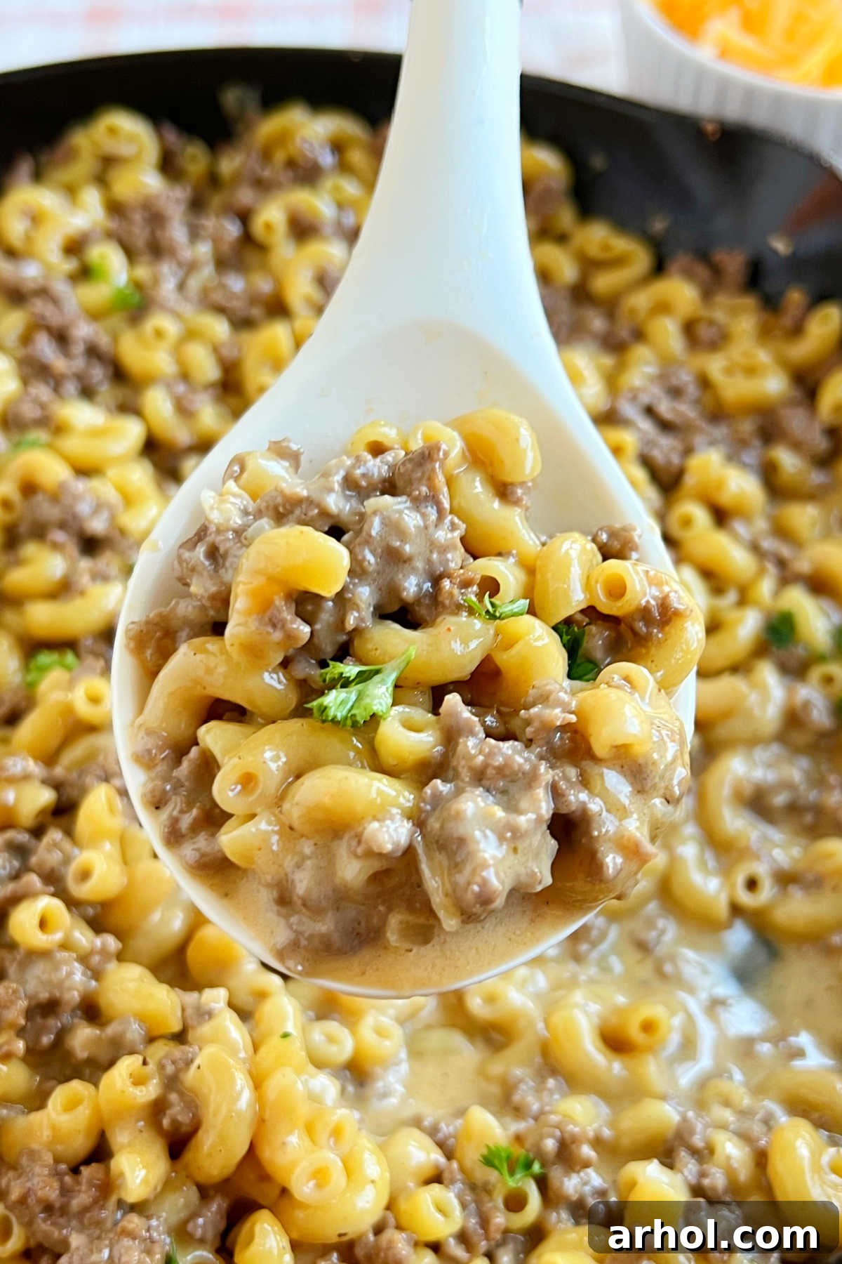homemade cheeseburger macaroni hamburger helper on a serving spoon.