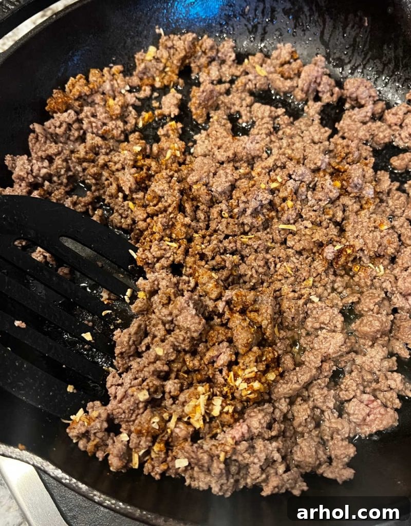 brown ground beef and spices in skillet.