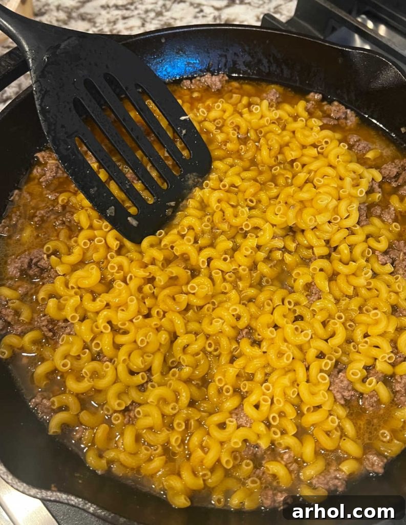 cook pasta in beef broth in skillet.