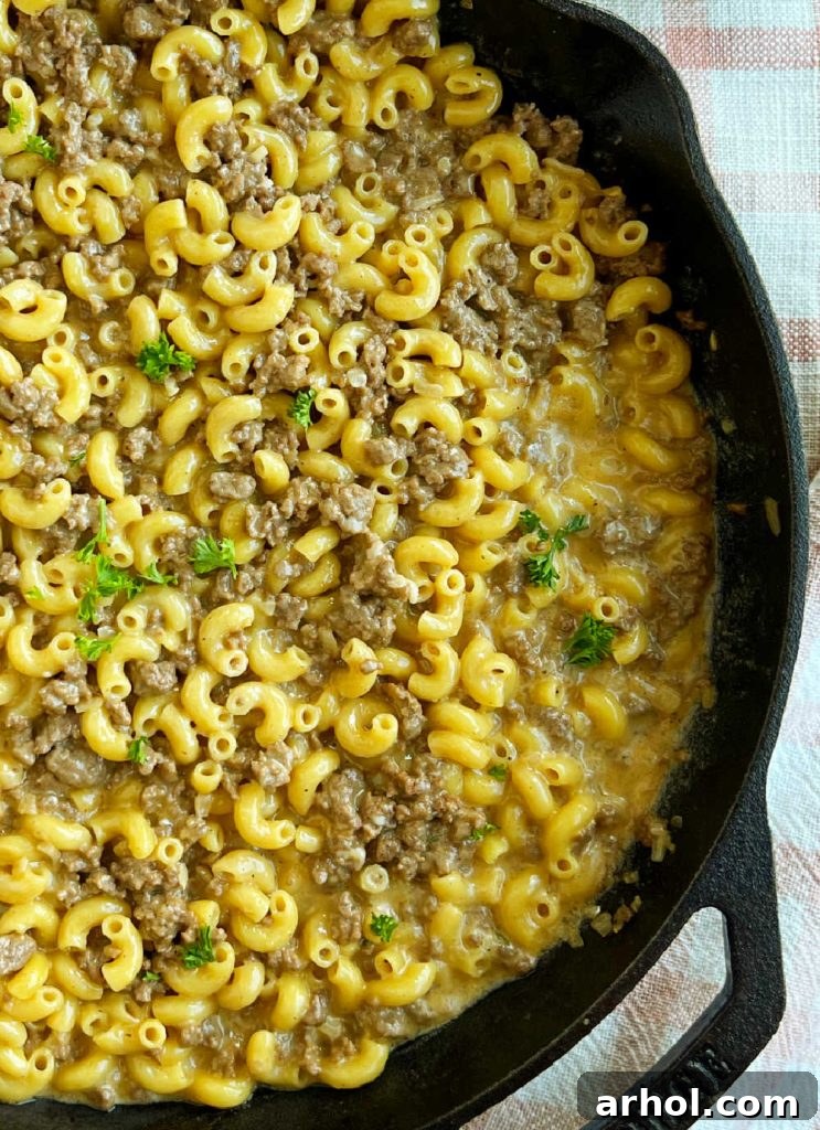 homemade cheeseburger macaroni in skillet with parsley.