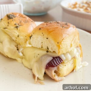 turkey sliders on Hawaiian rolls with cranberry sauce and cheese.