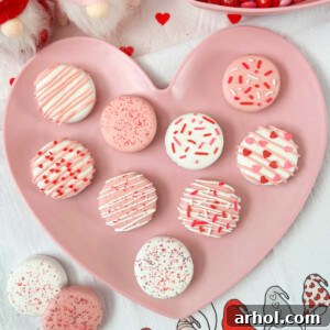 Close-up of white chocolate dipped Oreos covered with festive Valentine's Day sprinkles.