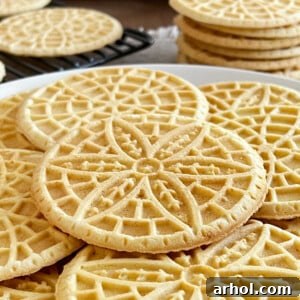 Stacks of delicious pizzelle cookies on the table, ready to be enjoyed.