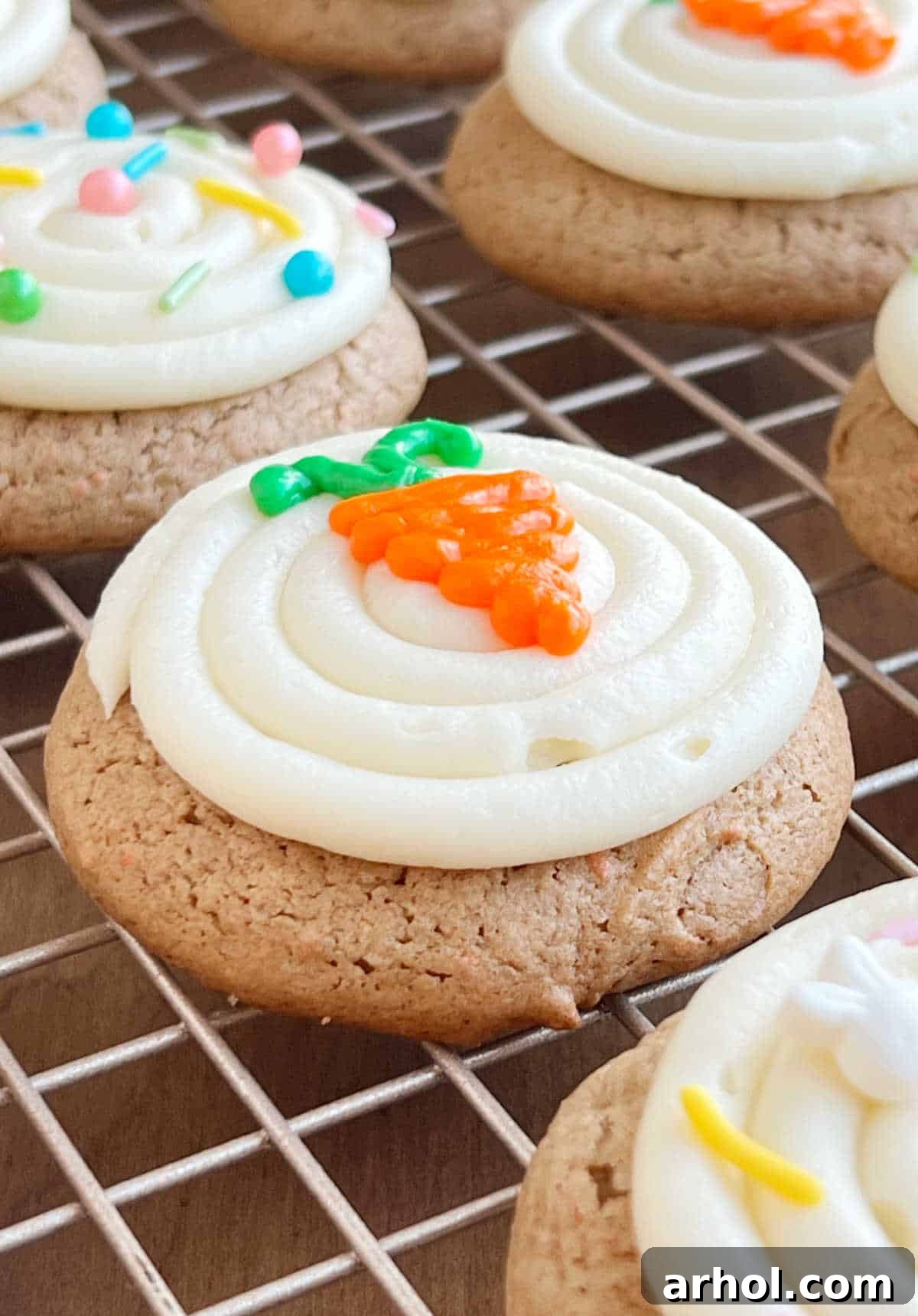 Beautifully frosted carrot cake mix cookies arranged on a wire baking rack, ready to be enjoyed.