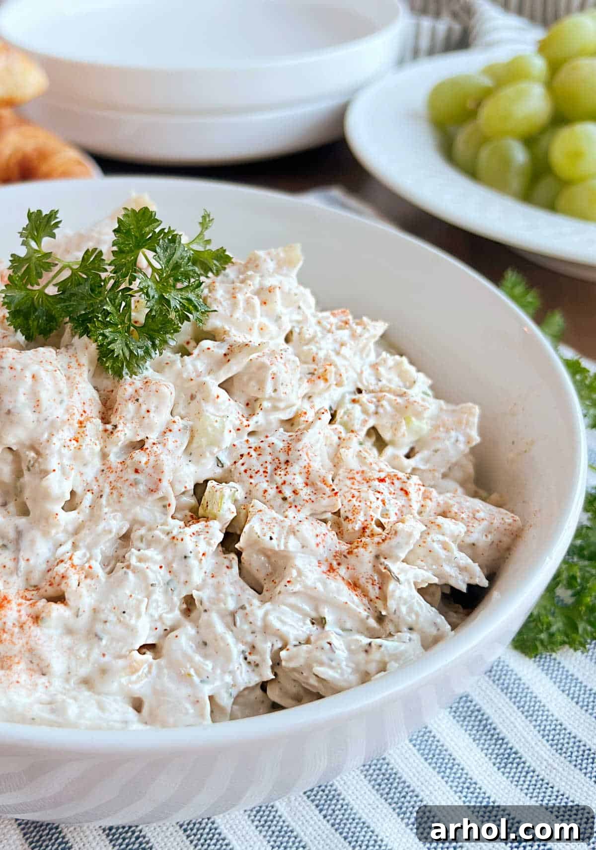 easy chicken salad in bowl with parsley on top.