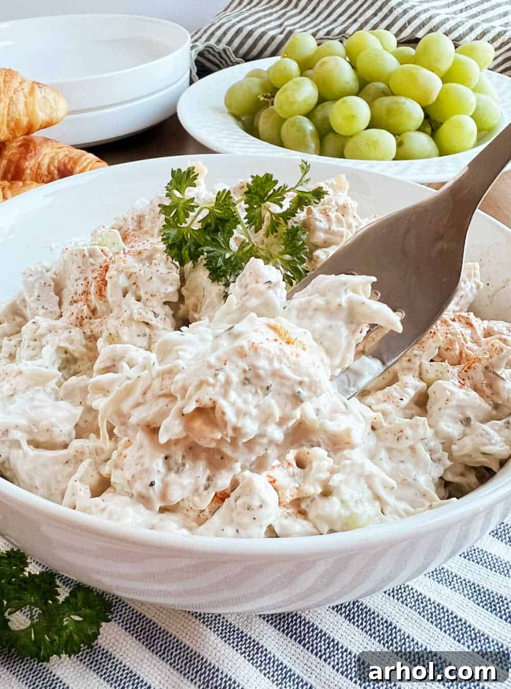 creamy chicken salad on a fork.