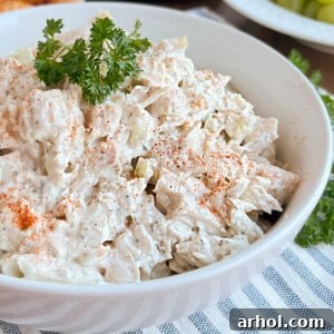 bowl of chicken salad with paprika and parsley.