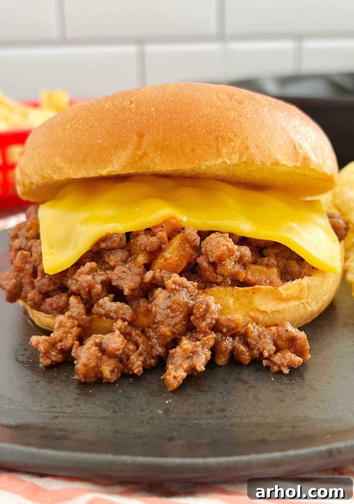 Sloppy Joe sandwich on brioche bun with American cheese.