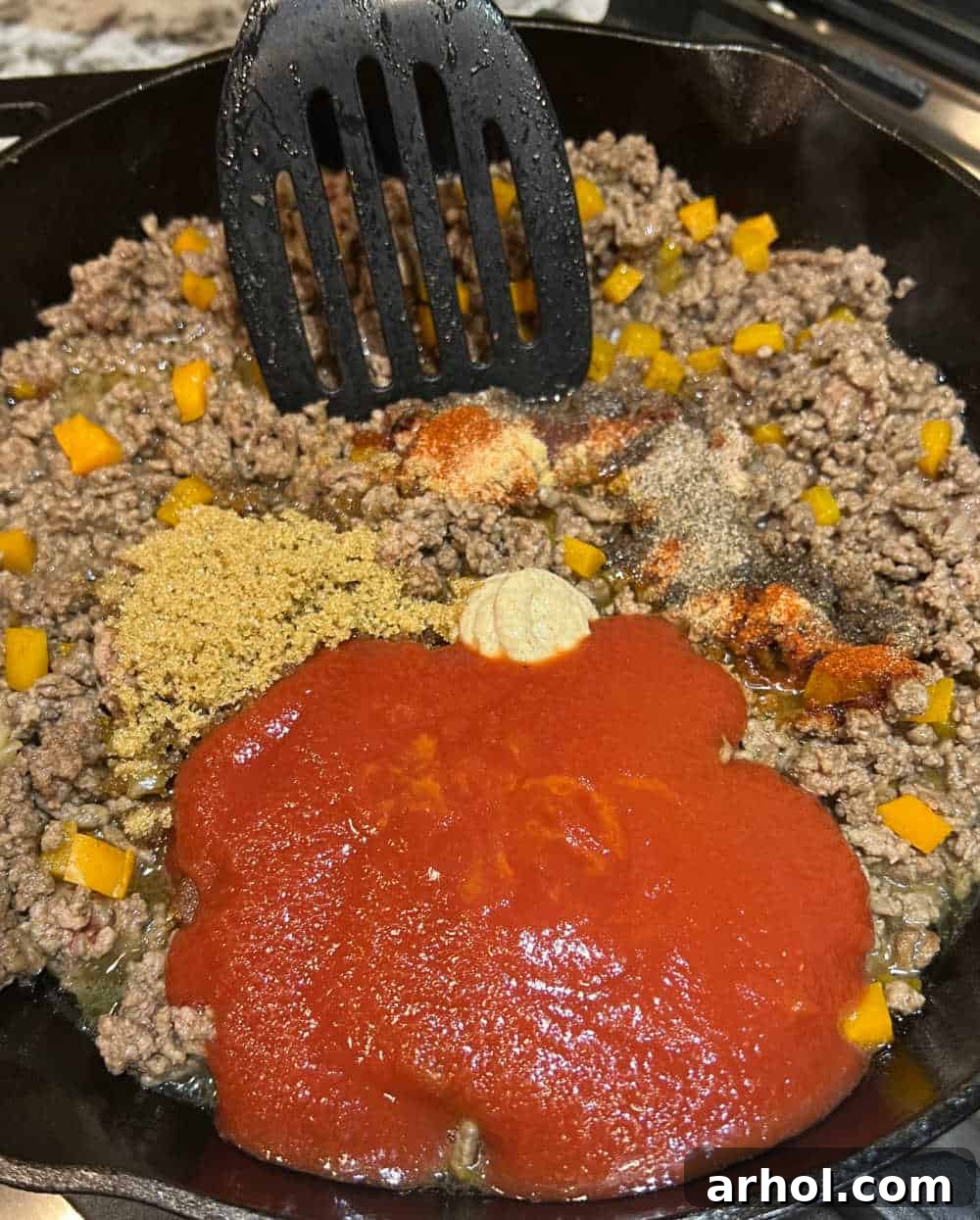 cook hamburger meat with tomato sauce in skillet.