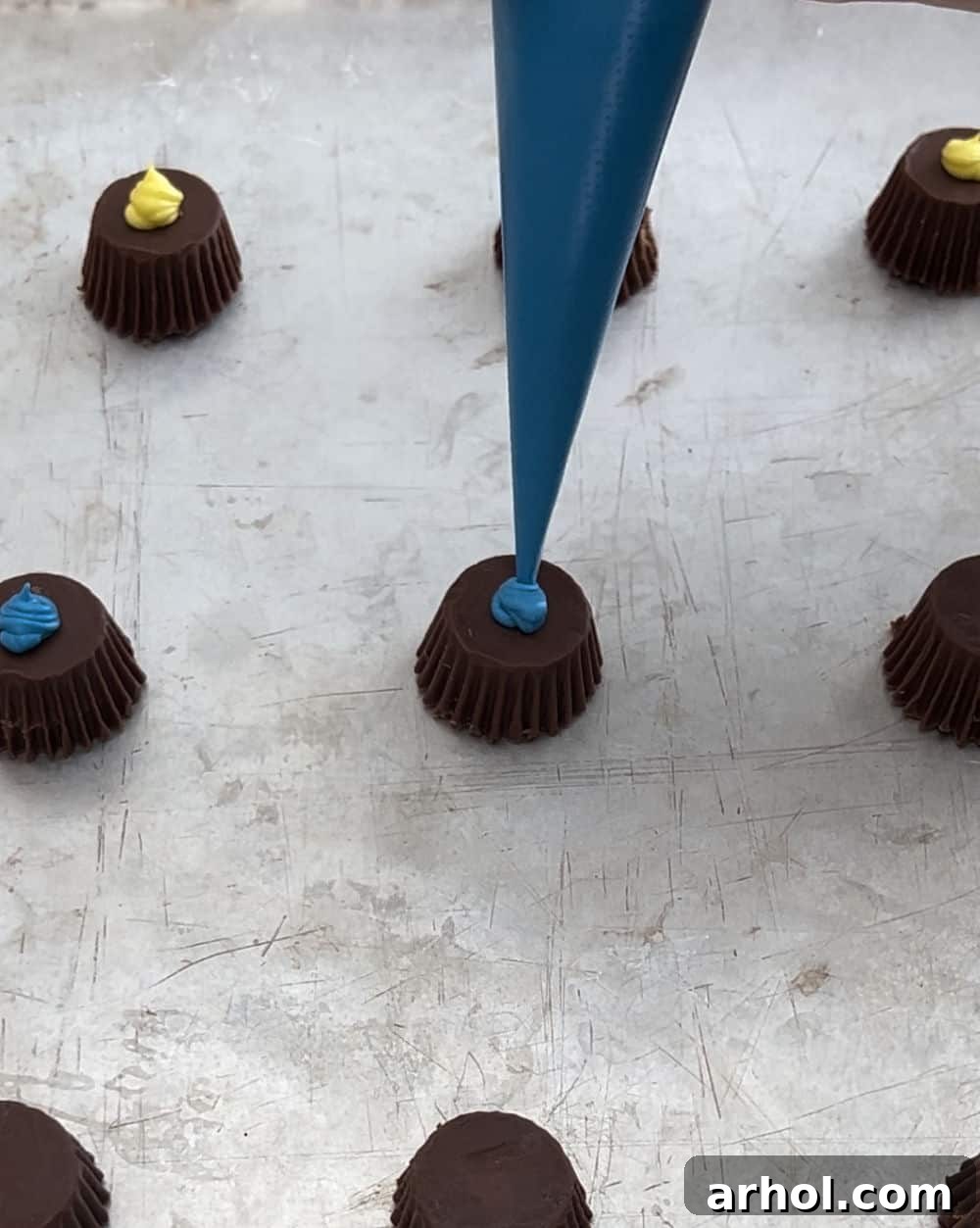pipe dab of frosting on peanut butter cup.