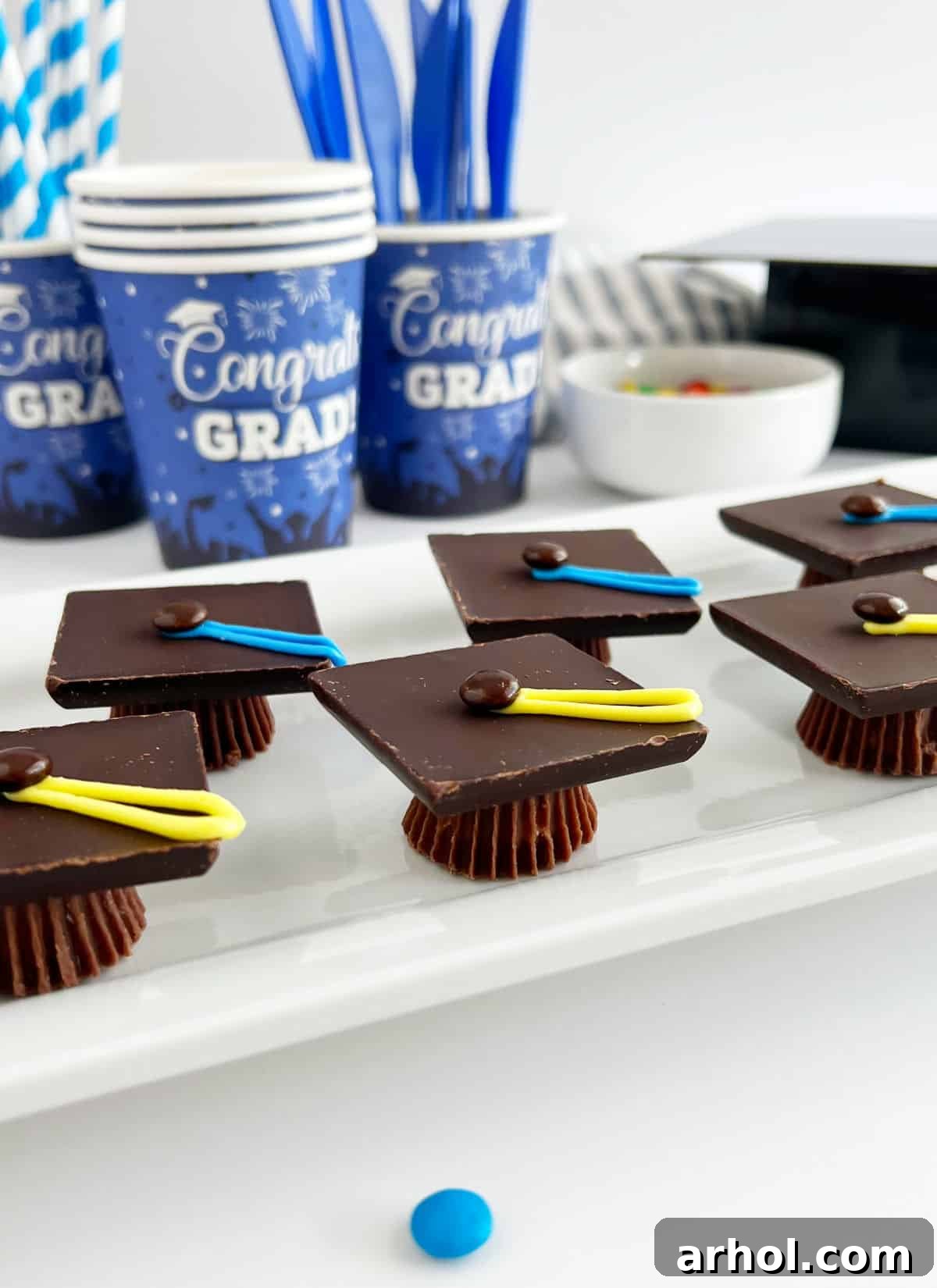 candy graduation caps treats on table with party supplies.