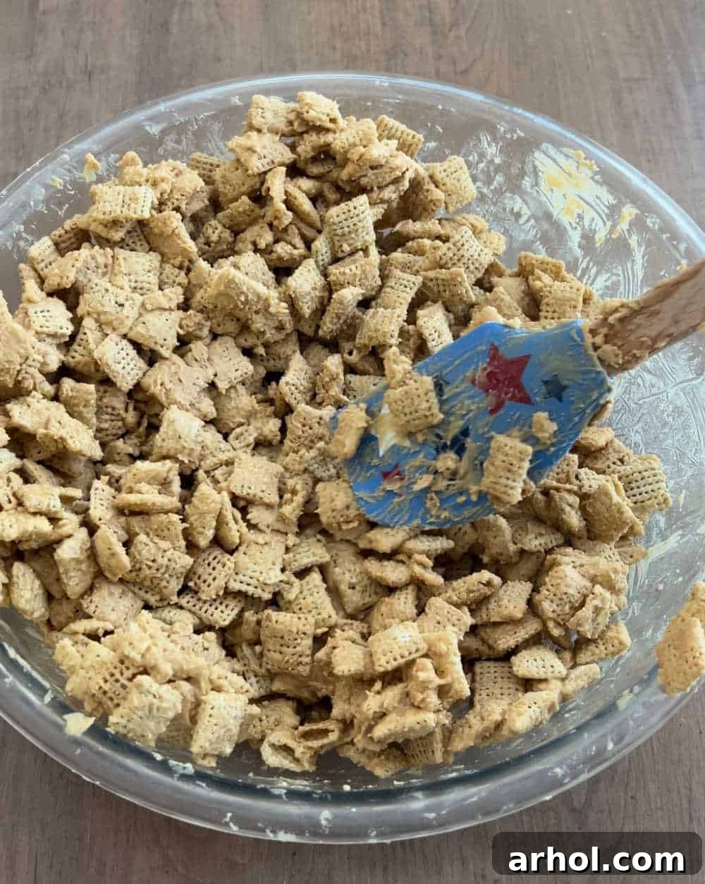 Star-Spangled Snack Mix 5 Mixing Rice Chex cereal with the peanut butter and white chocolate coating in a large bowl, ensuring every piece is evenly covered.