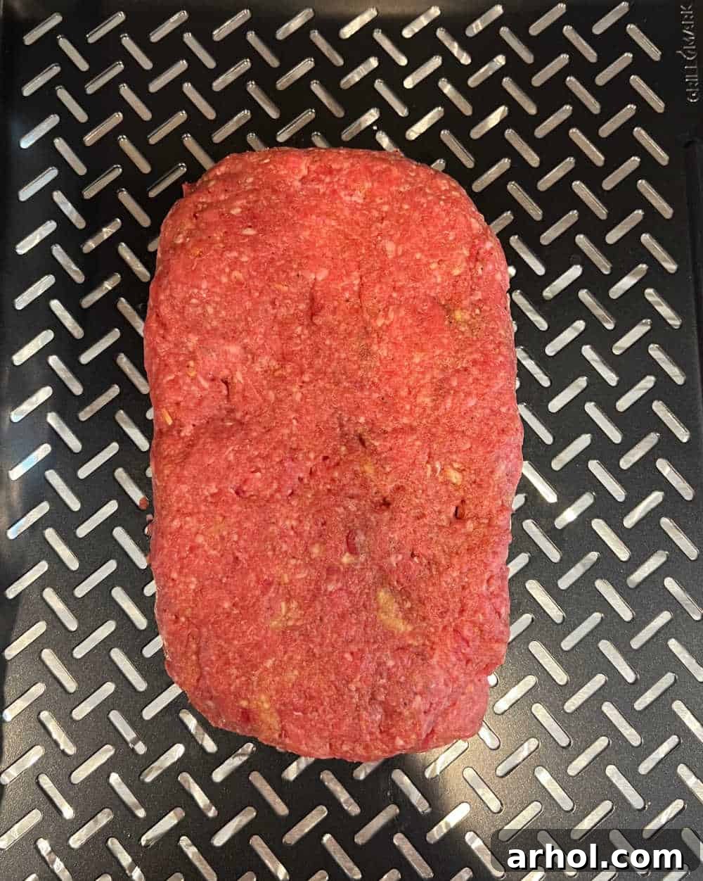Smoky Barbecue Glazed Meatloaf 4 Shaped loaf of ground beef on a smoker tray, ready for smoking.