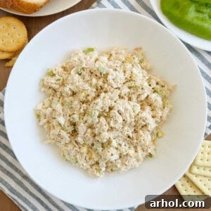 bowl of tuna salad with egg and celery on the table.