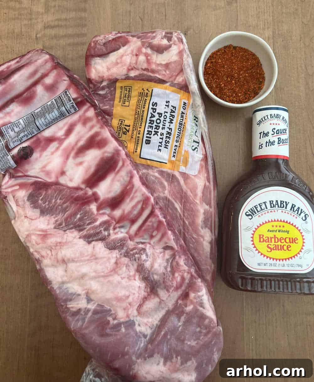 St. Louis ribs, a generous amount of BBQ rub, and a bottle of BBQ sauce laid out for smoking.