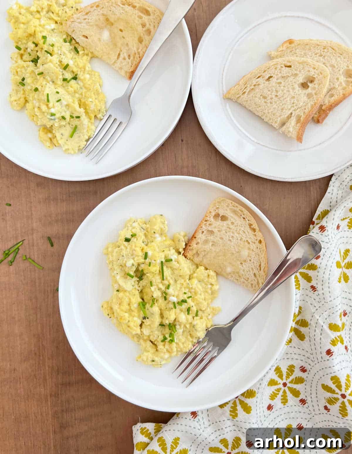 High Protein Cottage Cheese Egg Scramble 2 Plates of fluffy, high-protein cottage cheese scrambled eggs garnished with fresh chives and served alongside golden toast, ready for a healthy breakfast.