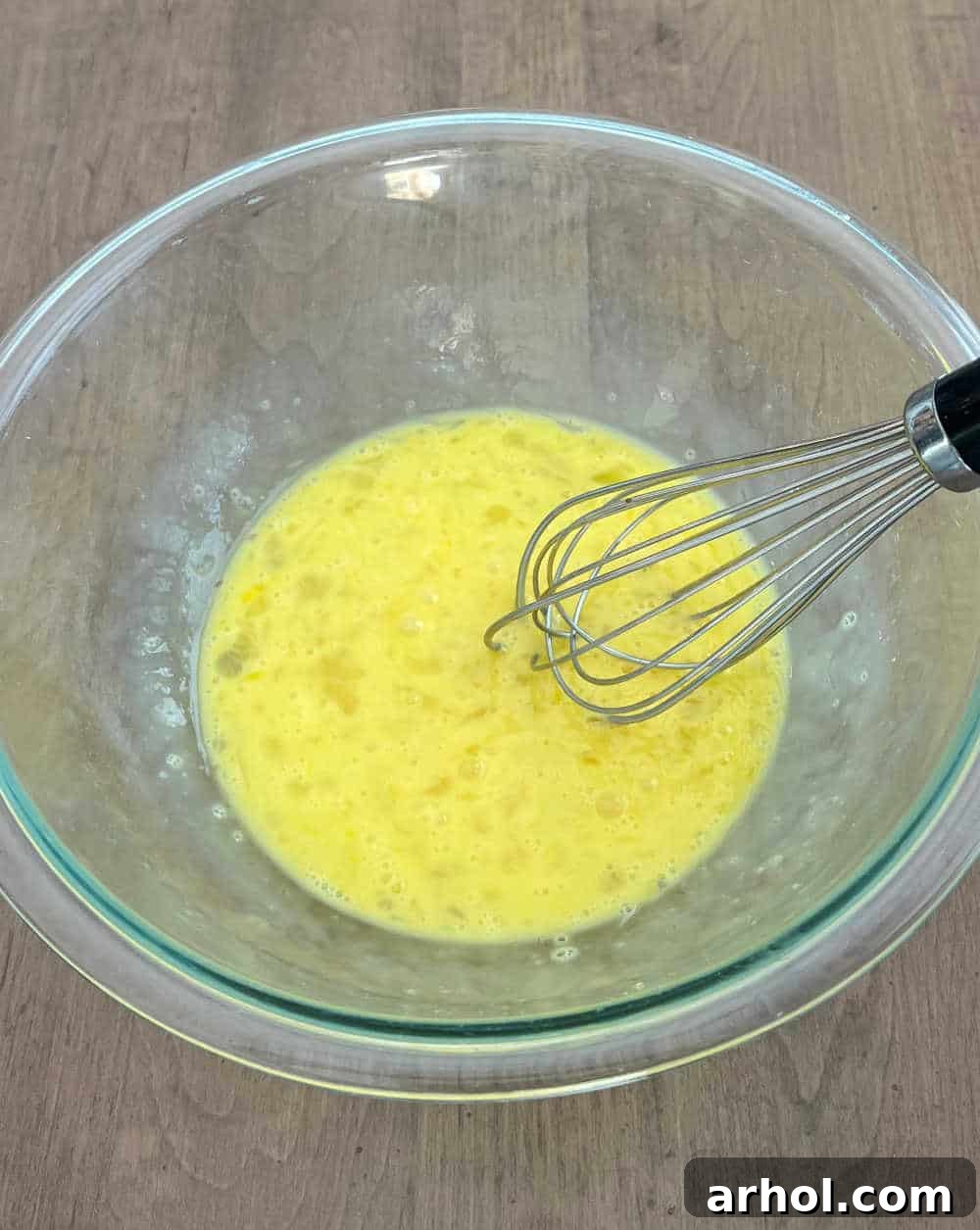 High Protein Cottage Cheese Egg Scramble 4 Whisking eggs in a mixing bowl for scrambled eggs.