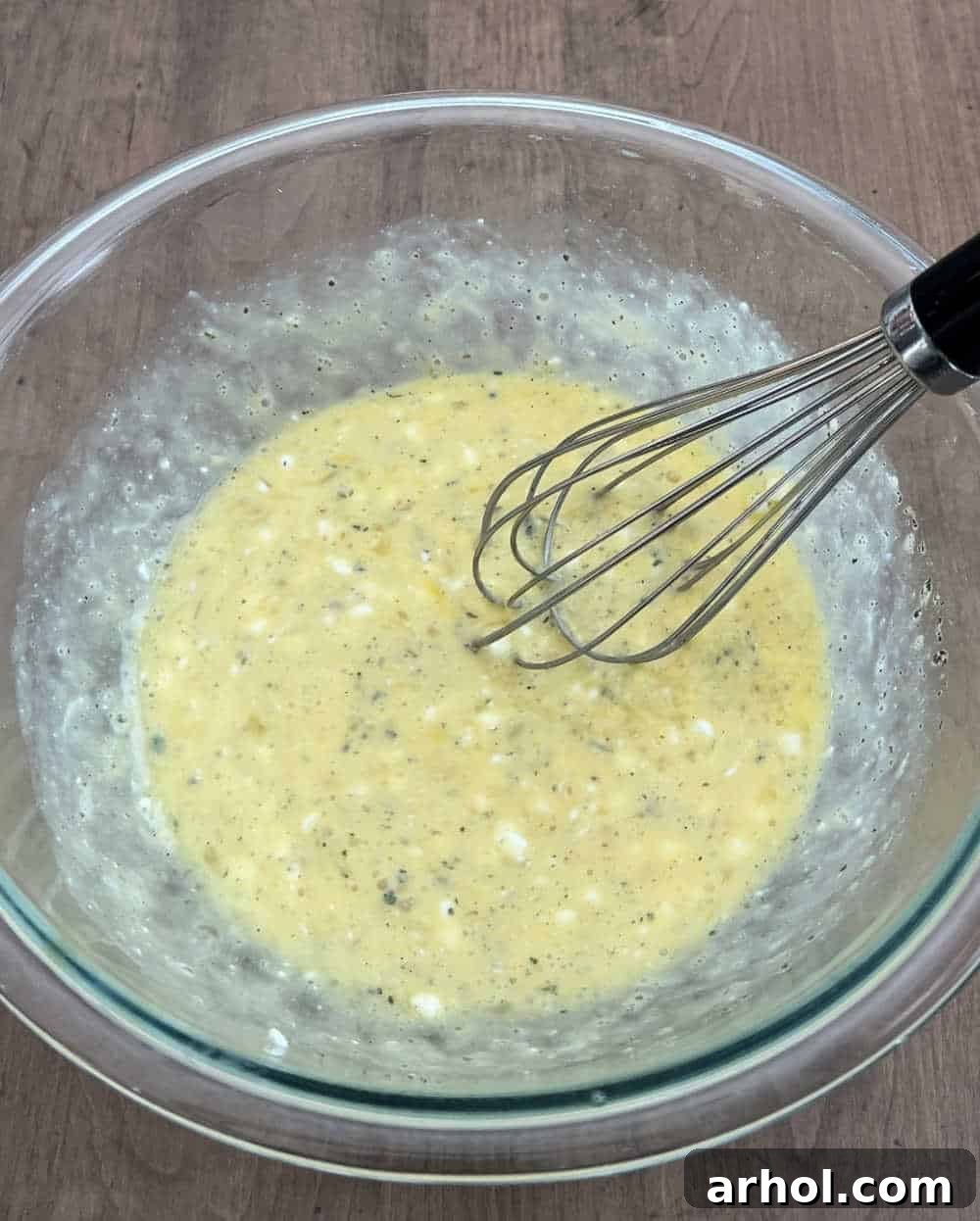 High Protein Cottage Cheese Egg Scramble 5 Mixing cottage cheese and seasonings into whisked eggs.