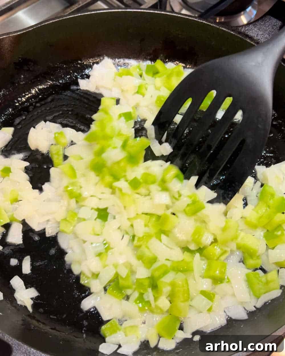 Sautéing onions and bell peppers in a large skillet until soft and fragrant.