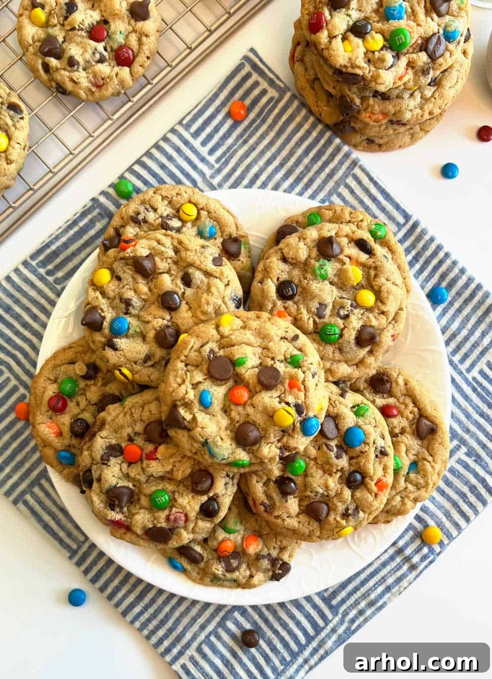 Beautiful stacks of monster cookies neatly arranged on a plate on the table, invitingly ready to be eaten.