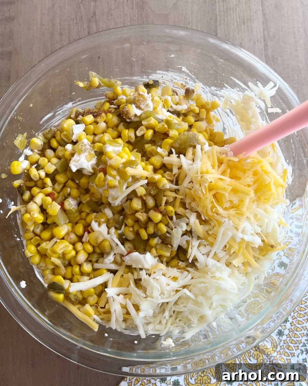 stir corn and cheese with cream cheese with spatula.
