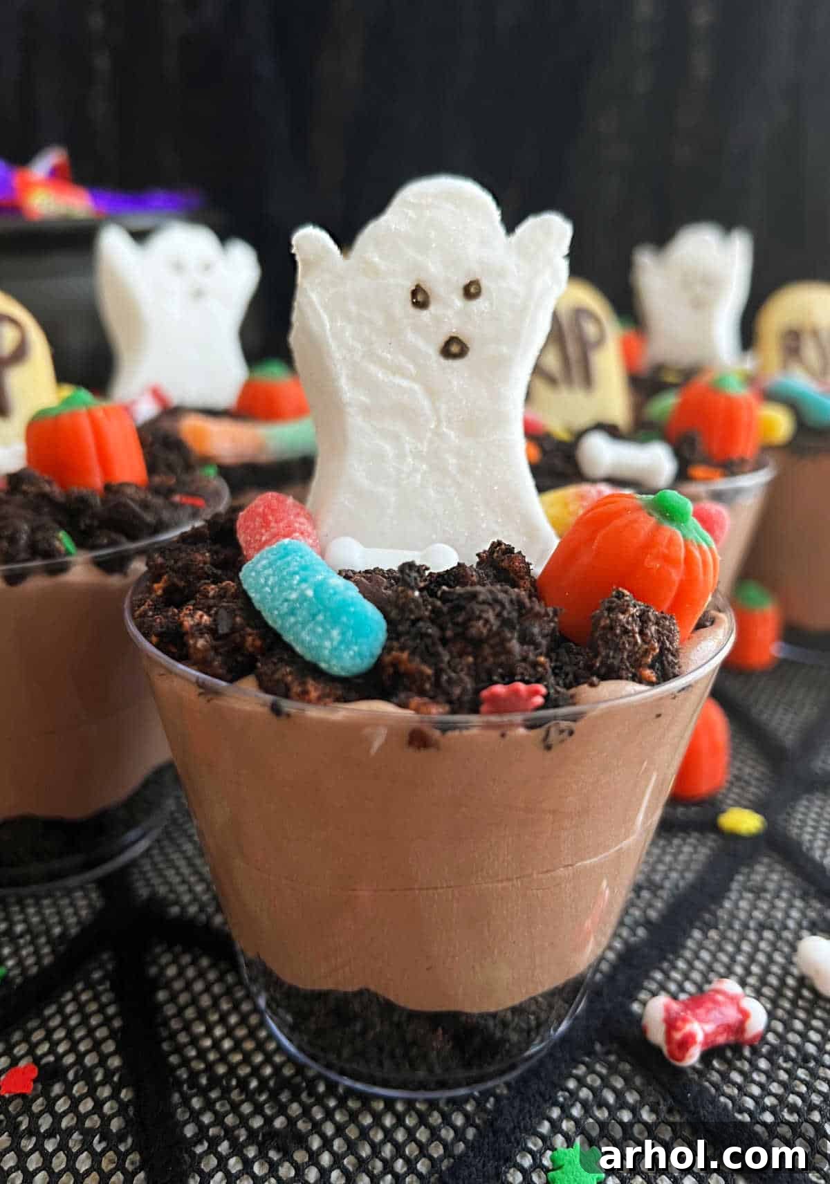 Quick Spooky Dirt Cups 2 Spooktacular Halloween dirt pudding cups adorned with a marshmallow ghost, ready for a festive party.