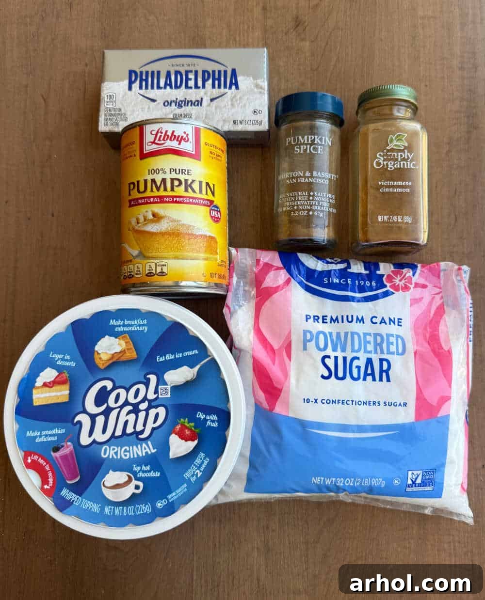 All the simple ingredients for homemade pumpkin cheesecake dip laid out on a kitchen counter.