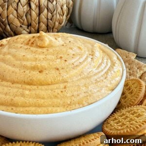 Pumpkin cream cheese dip in a serving bowl, garnished with cinnamon.