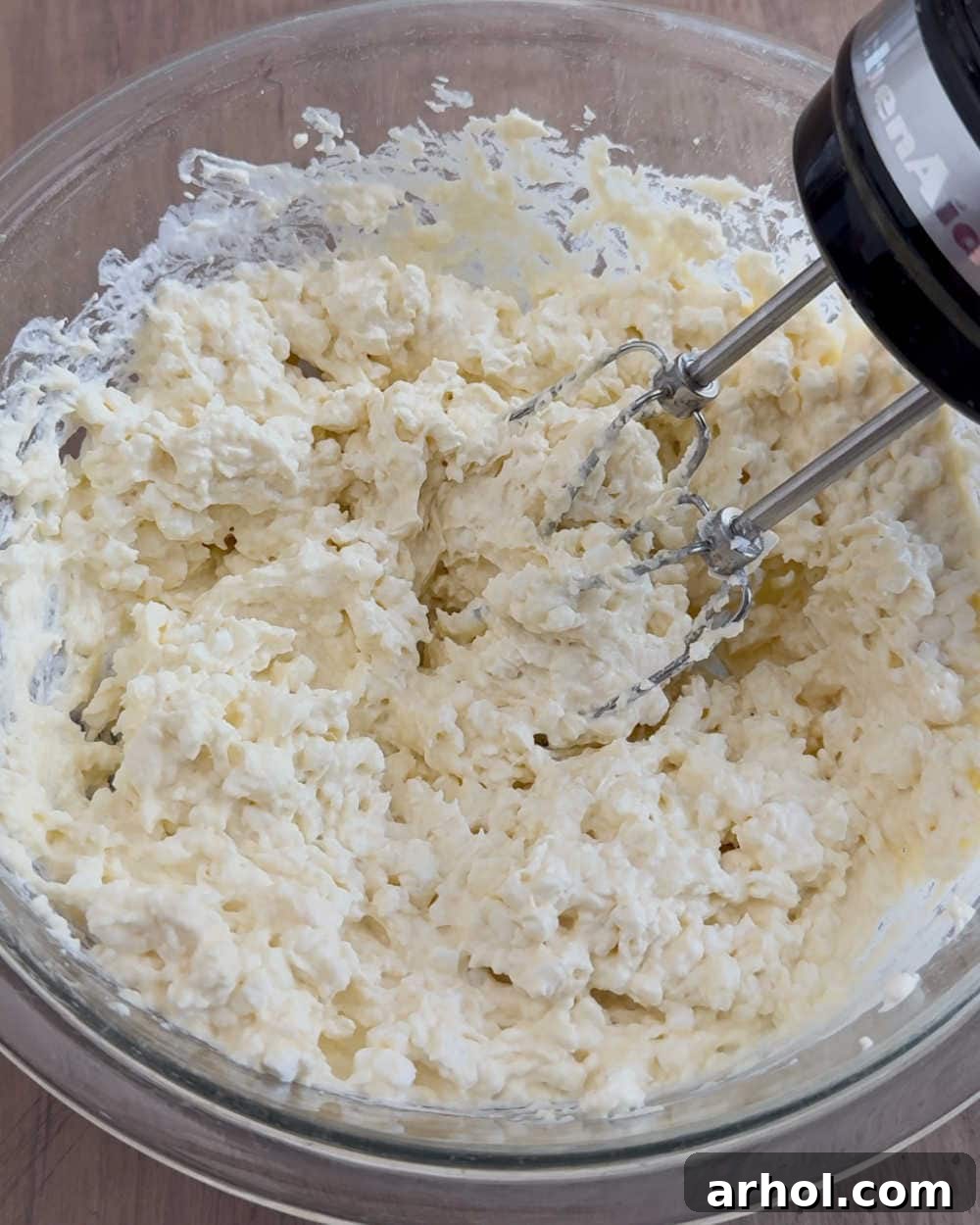 Mixing the creamy sauce ingredients in a large bowl with an electric mixer.
